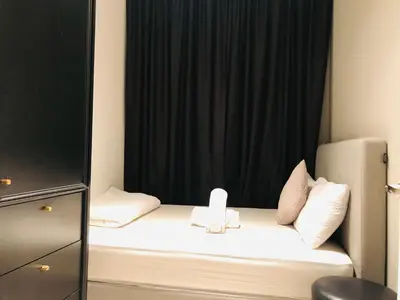 a small bed in a room with a black curtain at Axon Residence Glaxay Suite Bukit Bintang KL in Kuala Lumpur