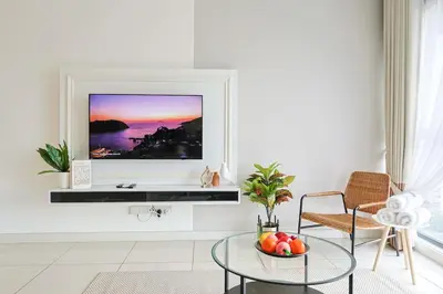a living room with a television on a wall at Continew Residensi City Comfort Stay Cozy 1BR 1BA in Kuala Lumpur