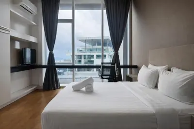 a bedroom with a large bed with a large window at Platinum Klcc by PureStay in Kuala Lumpur