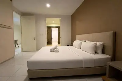 a bedroom with a bed with a stuffed animal on it at Platinum Klcc by PureStay in Kuala Lumpur