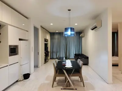 a dining room with a table and a kitchen at Platinum Klcc by PureStay in Kuala Lumpur