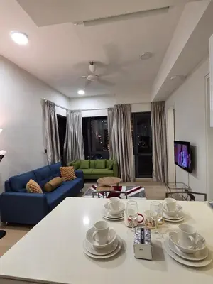 a living room with a table with dishes on it at KL Star Residance KLCC by Nexus 111 in Kuala Lumpur