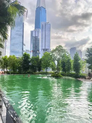a pool of green water in a city with tall buildings at Agile Bukit Bintang TRX by AR in Kuala Lumpur