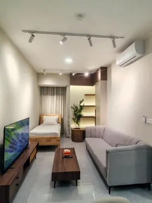 a living room with a couch and a tv at Agile Bukit Bintang TRX by AR in Kuala Lumpur