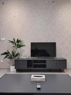 a black entertainment center with a flat screen tv on it at Agile Bukit Bintang TRX by AR in Kuala Lumpur