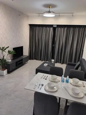 a living room with a table and chairs and a television at Agile Bukit Bintang TRX by AR in Kuala Lumpur