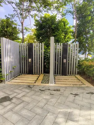 a gate in the middle of a sidewalk with trees at Agile Bukit Bintang TRX by AR in Kuala Lumpur