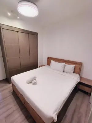 a bedroom with a large white bed with a wooden headboard at Agile Bukit Bintang TRX by AR in Kuala Lumpur