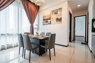 a dining room with a black table and chairs at Opus Residences KL by PILLOWTALKS in Kuala Lumpur