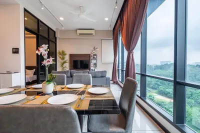 a dining room with a table and chairs and large windows at Opus Residences KL by PILLOWTALKS in Kuala Lumpur