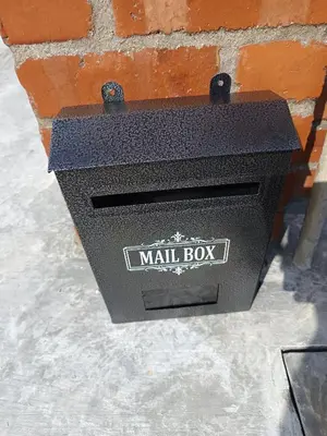 a mail box attached to a brick wall at Family Landed Homestay in Pandan Jaya, Ampang near KLCC in Kuala Lumpur