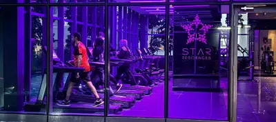a group of people exercising on machines in a gym at Star residence in Kuala Lumpur