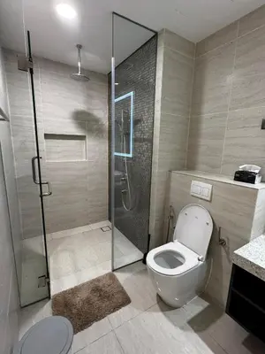 a bathroom with a toilet and a glass shower at Star residence in Kuala Lumpur