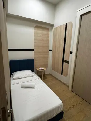 a small room with a bed and a mirror at Star residence in Kuala Lumpur