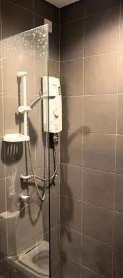 a bathroom with a soap dispenser on a wall at summer suite, KLCC in Kuala Lumpur