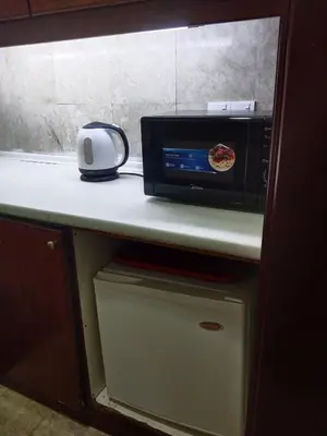 a microwave oven sitting on top of a counter at Krish Apartment At Times Square in Kuala Lumpur