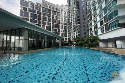 a large swimming pool in a building with tall buildings at The Ooak Suites Kiara 163 by Five Senses in Kuala Lumpur