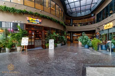 an empty shopping mall with a lot of potted plants at The Ooak Suites Kiara 163 by Five Senses in Kuala Lumpur
