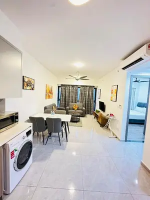 a kitchen and living room with a table and a couch at Agile Bukit Bintang Sky Pavillion at TRX in Kuala Lumpur