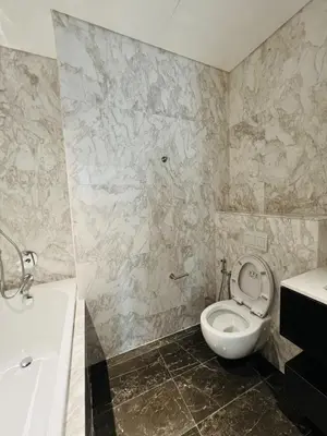 a bathroom with a toilet and a sink and a tub at So Sofitel KL Residences in Kuala Lumpur
