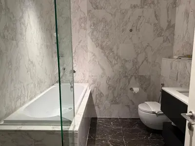 a bathroom with a shower and a toilet and a tub at So Sofitel KL Residences in Kuala Lumpur