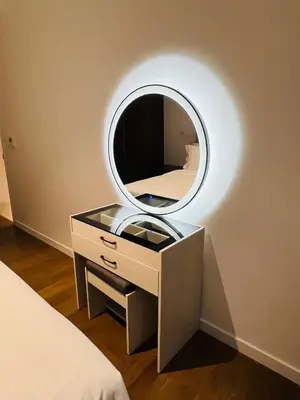 a mirror on a dresser with a bed in a bedroom at So Sofitel KL Residences in Kuala Lumpur