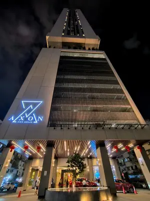 a tall building with cars parked in front of it at The Excellent Axon Residence Bukit Bintang KL in Kuala Lumpur