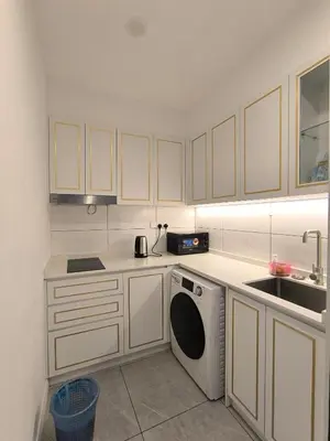a kitchen with a washing machine and a sink at The Excellent Axon Residence Bukit Bintang KL in Kuala Lumpur