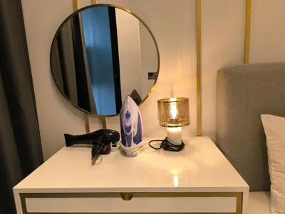 a white table with a mirror and a lamp on it at The Excellent Axon Residence Bukit Bintang KL in Kuala Lumpur