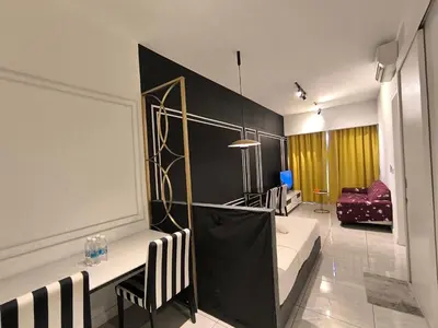 a living room with a couch and a table and chairs at The Excellent Axon Residence Bukit Bintang KL in Kuala Lumpur