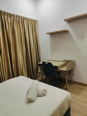 a room with a bed and a desk with a desk at Grand infinitum suites KLCC by PN in Kuala Lumpur
