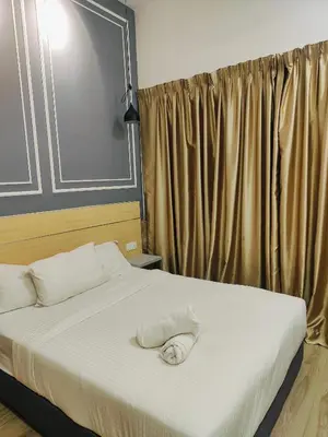 a bedroom with a bed with a towel on it at Grand infinitum suites KLCC by PN in Kuala Lumpur