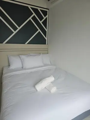 a white bed with two white pillows on it at Grand infinitum suites KLCC by PN in Kuala Lumpur