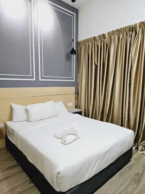 a bedroom with a large bed with white sheets at Grand infinitum suites KLCC by PN in Kuala Lumpur