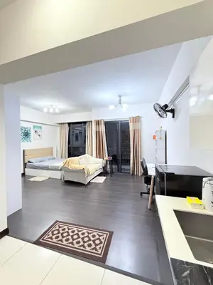a bedroom with a bed and a living room at Sea Homestay in Kuala Lumpur