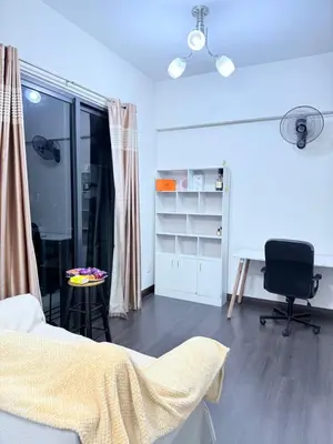 a bedroom with a bed and a desk and a chair at Sea Homestay in Kuala Lumpur