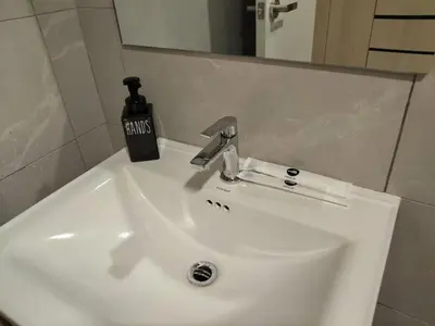 a white bathroom sink with a soap dispenser on it at Kampung Marsa Retreat, Majestic Residence, KL in Kuala Lumpur