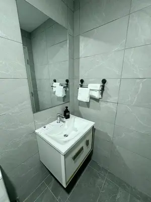a white bathroom with a sink and a mirror at Kampung Marsa Retreat, Majestic Residence, KL in Kuala Lumpur