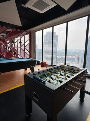 a large pool table in a room with windows at Kampung Marsa Retreat, Majestic Residence, KL in Kuala Lumpur