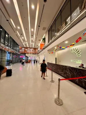 a man walking down a hallway in a shopping mall at 2 Bedroom Apartment Near KLCC 5 minutes Walk in Kuala Lumpur