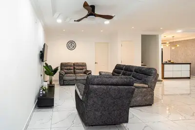 a living room with two couches and a ceiling fan at Seputeh 2Sty House - 10 min to MidValley KL Gateway Bangsar in Kuala Lumpur