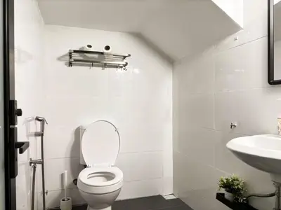 a white bathroom with a toilet and a sink at Seputeh 2Sty House - 10 min to MidValley KL Gateway Bangsar in Kuala Lumpur