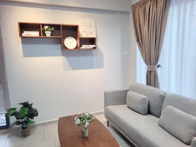 a living room with a couch and a table at Isola KLCC Residence in Kuala Lumpur