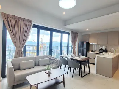a living room with a couch and a table and a kitchen at Isola KLCC Residence in Kuala Lumpur