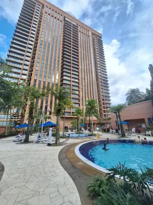 a hotel with a swimming pool in front of a building at KL Residences at Berjaya Times Square in Kuala Lumpur