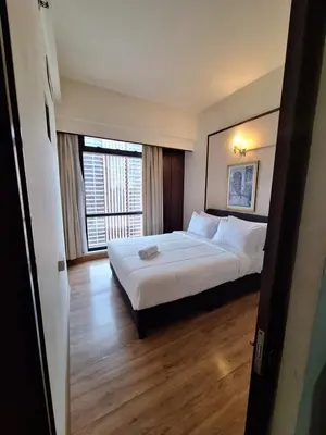 a hotel room with a bed and a large window at KL Residences at Berjaya Times Square in Kuala Lumpur
