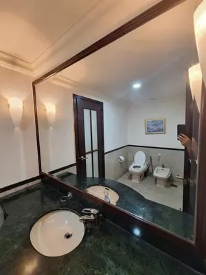 a bathroom with a sink and a toilet and a mirror at KL Residences at Berjaya Times Square in Kuala Lumpur