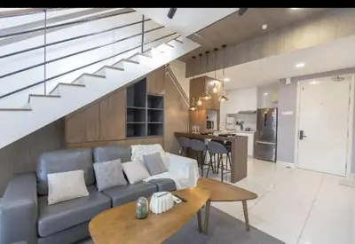 a living room with a couch and a table at BMC Arte Mont Kiara in Kuala Lumpur