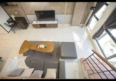 an overhead view of a living room with a couch and a table at BMC Arte Mont Kiara in Kuala Lumpur