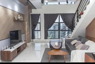 a living room with a couch and a tv at BMC Arte Mont Kiara in Kuala Lumpur